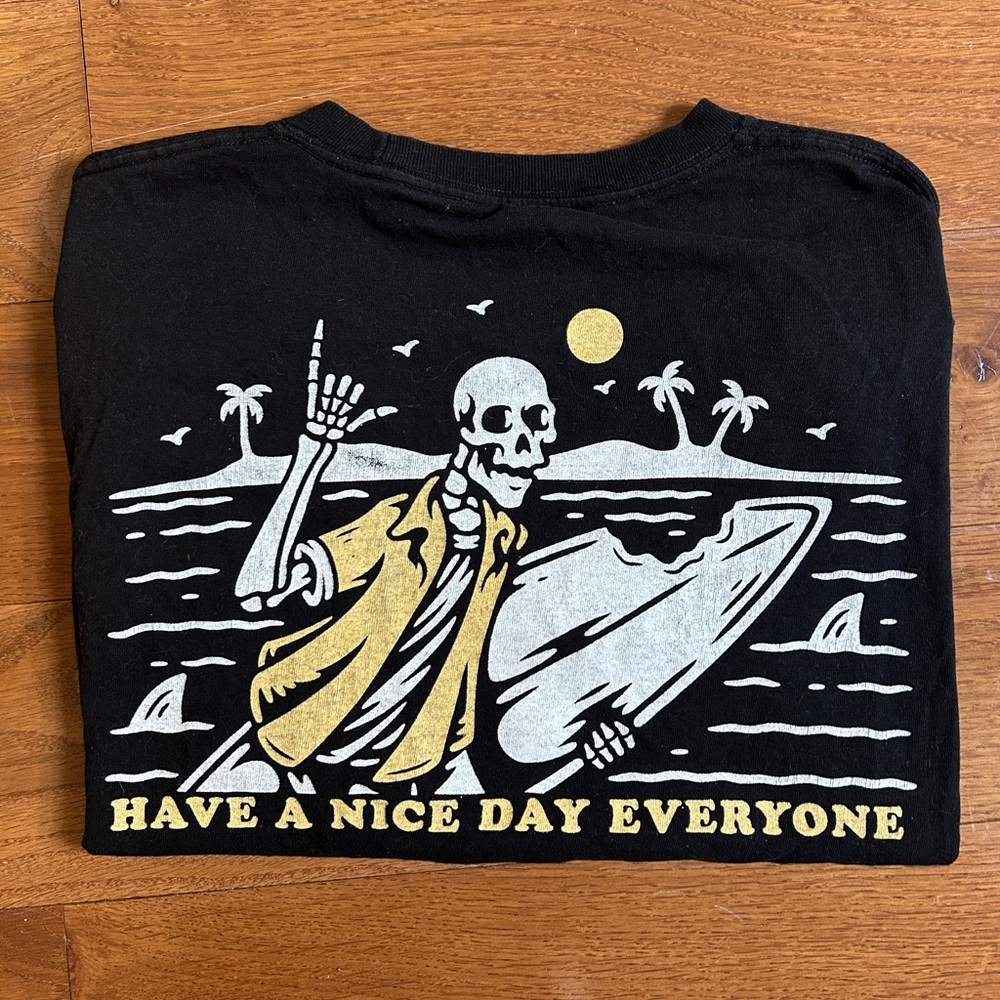 Oversized Cropped Black Graphic Tee with Skeleton Surfer Design